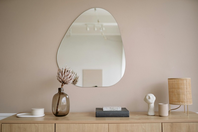 Frameless Mirror on a Wall Above a Cabinet

