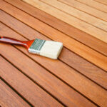 Paint brush on a wooden deck