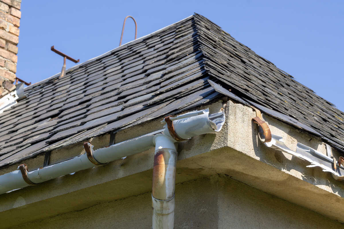 Broken guttering on the roof of a house