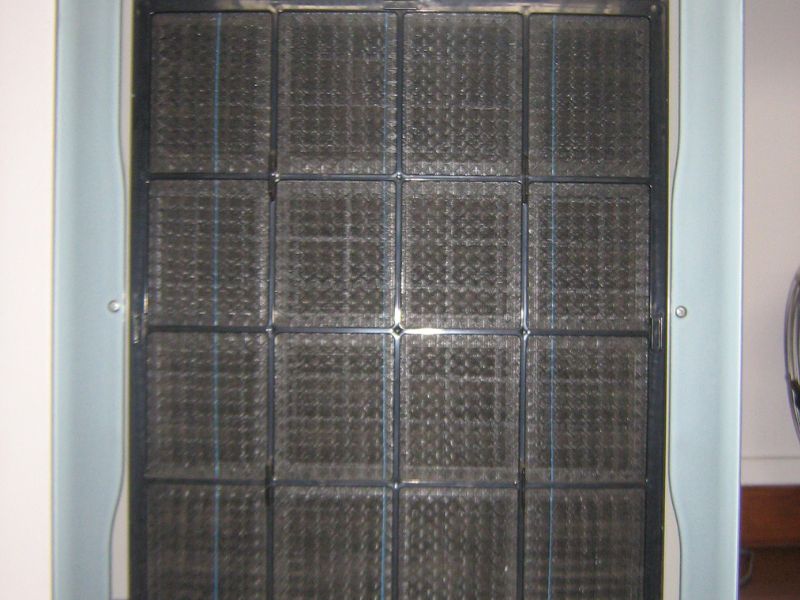 A permanent electrostatic HVAC filter with a visible grid structure, designed to be cleaned and reused, part of an air purification system.