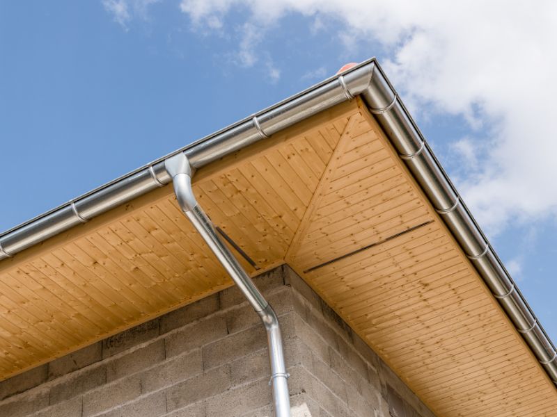 New zinc gutter on a house construction
