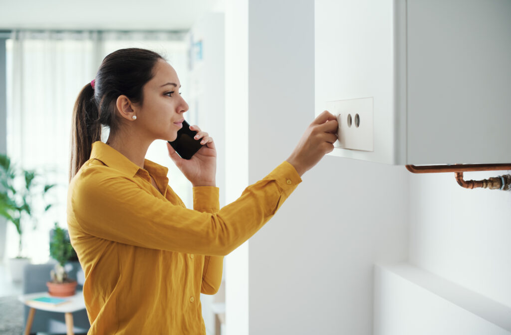 woman adjusting boiler heating speed