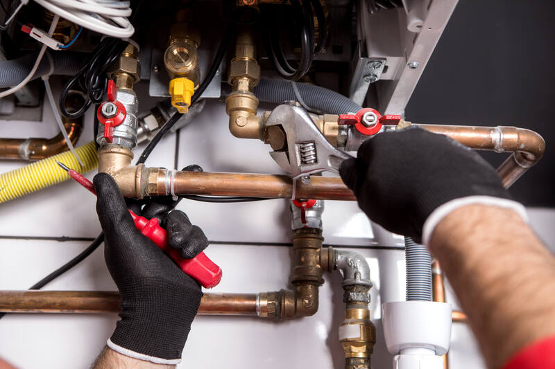 A plumber fixing central heating system , boiler maintenance