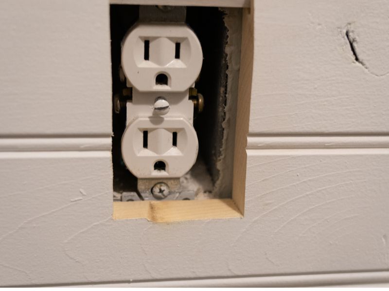 An electrical outlet is recessed after shiplap wood paneling is applied to the wall, the outlet must now be extended. 
