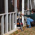 How to Remove a Hinged Screen Door Homeowner works on repairing door to screened in back porch