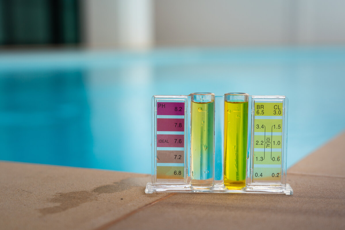Checking water quality of swimming pool by using chemical test kit to compare PH and chlorine concentration