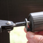 Extreme closeup of the hold-open washer on a storm door closer mechanism