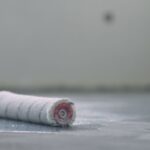 closeup of applying protective coating on the concrete floor using a paint roller