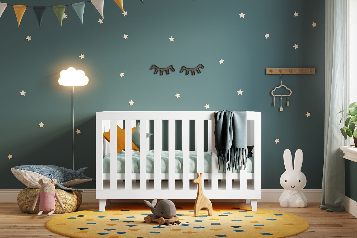 green nursery interior with a white cradle lots of toys and colorful flags