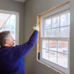 How to Soundproof a Window Using spray foam to seal a window frame for soundproofing and insulation.